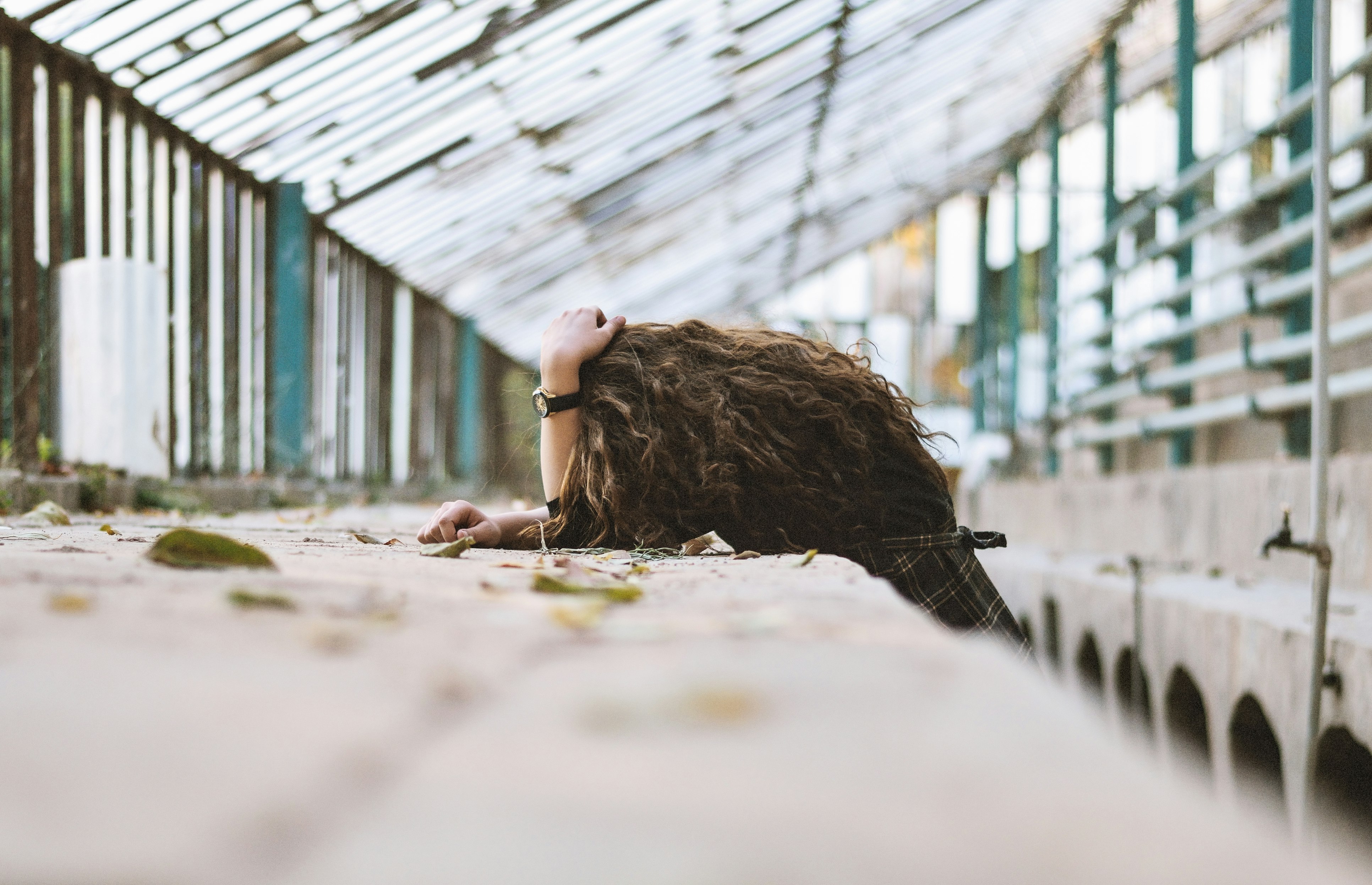 brown haired girl lying on ground